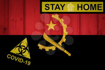 Flag of the Angola in original proportions. Quarantine and isolation - Stay at home. flag with biohazard symbol and inscription COVID-19.