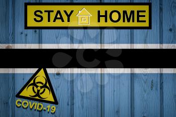Flag of the Botswana in original proportions. Quarantine and isolation - Stay at home. flag with biohazard symbol and inscription COVID-19.