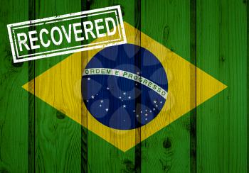 flag of Brazil that survived or recovered from the infections of corona virus epidemic or coronavirus. Grunge flag with stamp Recovered
