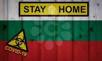 Flag of the Bulgaria in original proportions. Quarantine and isolation - Stay at home. flag with biohazard symbol and inscription COVID-19.
