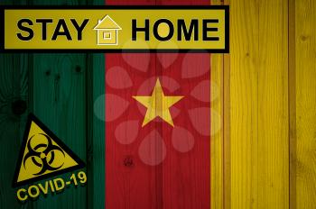 Flag of the Cameroon in original proportions. Quarantine and isolation - Stay at home. flag with biohazard symbol and inscription COVID-19.