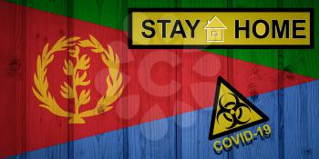 Flag of the Eritrea in original proportions. Quarantine and isolation - Stay at home. flag with biohazard symbol and inscription COVID-19.