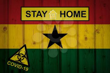 Flag of the Ghana in original proportions. Quarantine and isolation - Stay at home. flag with biohazard symbol and inscription COVID-19.