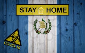 Flag of the Guatemala in original proportions. Quarantine and isolation - Stay at home. flag with biohazard symbol and inscription COVID-19.