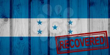 flag of Honduras that survived or recovered from the infections of corona virus epidemic or coronavirus. Grunge flag with stamp Recovered