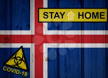 Flag of the Iceland in original proportions. Quarantine and isolation - Stay at home. flag with biohazard symbol and inscription COVID-19.