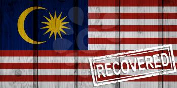 flag of Malaysia that survived or recovered from the infections of corona virus epidemic or coronavirus. Grunge flag with stamp Recovered