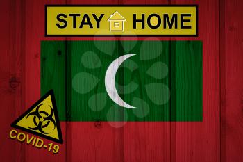 Flag of the Maldives in original proportions. Quarantine and isolation - Stay at home. flag with biohazard symbol and inscription COVID-19.