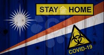 Flag of the Marshall Islands i in original proportions. Quarantine and isolation - Stay at home. flag with biohazard symbol and inscription COVID-19.