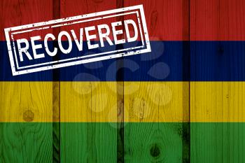 flag of Mauritius that survived or recovered from the infections of corona virus epidemic or coronavirus. Grunge flag with stamp Recovered