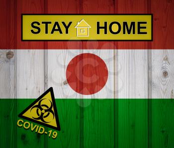 Flag of the Niger in original proportions. Quarantine and isolation - Stay at home. flag with biohazard symbol and inscription COVID-19.
