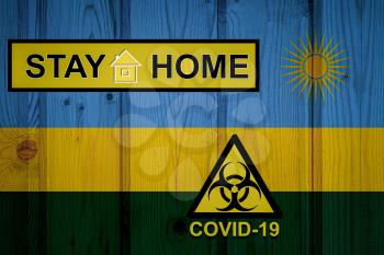 Flag of the Rwanda in original proportions. Quarantine and isolation - Stay at home. flag with biohazard symbol and inscription COVID-19.