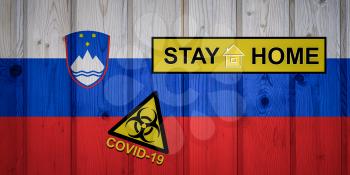 Flag of the Slovenia in original proportions. Quarantine and isolation - Stay at home. flag with biohazard symbol and inscription COVID-19.
