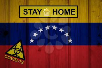 Flag of the Venezuela in original proportions. Quarantine and isolation - Stay at home. flag with biohazard symbol and inscription COVID-19.