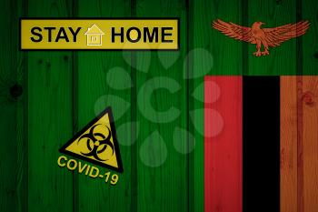 Flag of the Zambia in original proportions. Quarantine and isolation - Stay at home. flag with biohazard symbol and inscription COVID-19.