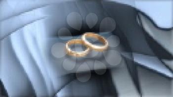 Royalty Free Video of Rotating Wedding Rings on a Grey Pillow